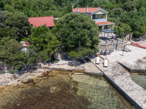 an aerial view of a house next to a body of water at Holiday Home Baricevic in Posedarje