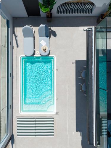 a swimming pool on the side of a house at Ciel Seafront Suites - Lefkada in Lygia