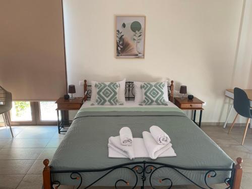 a bedroom with a bed with white towels on it at Daniel's Hotel Apartments in Paphos