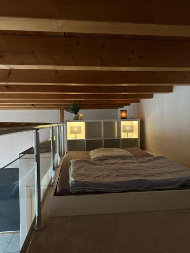 a bedroom with a large bed with lights on it at Ferienwohnung Loft ca. 45 qm in Anröchte