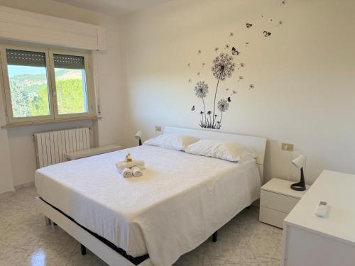 a bedroom with a bed with a teddy bear on it at Casa Dulce Casa - Bright flat with balcony 2 baths 2 beds in Scafa