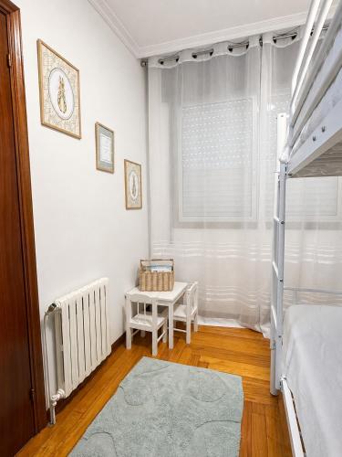 a bedroom with a bunk bed and a table at Casa Ona in Pontevedra