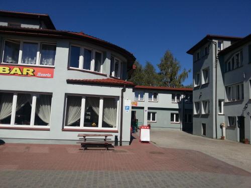 a white building with a bench in front of it at Henrix in Warsaw