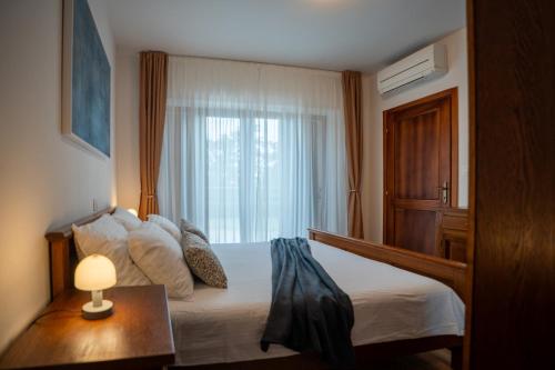 a bedroom with a large bed with a window at Villa Elida with Heated Pool - Central Istria in Pazin