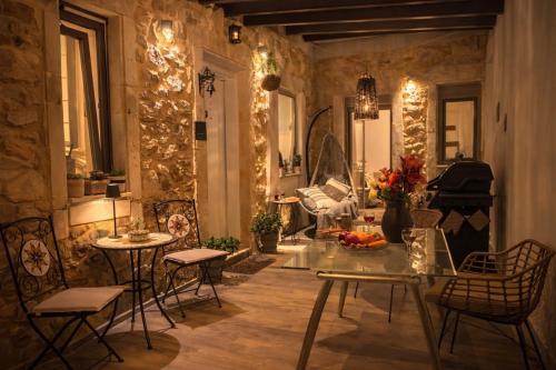 a living room with a table and chairs and a piano at Villa Katrinia in Sitia