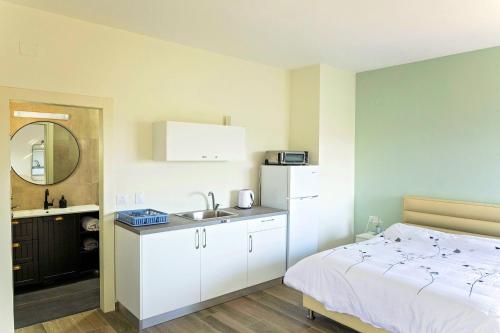 a kitchen with a bed and a sink in a room at נוף המצוק בגליל in Even Menahem