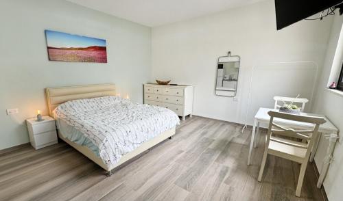 a bedroom with a bed and a table and a desk at נוף המצוק בגליל in Even Menahem