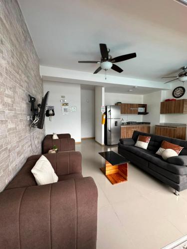 a living room with a couch and a ceiling fan at Casa Paraíso in San Jerónimo