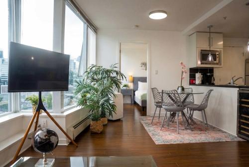 a living room with a flat screen tv on a tripod at Gorgeous Unit with City Views in Vancouver
