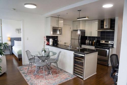 a kitchen with a table and chairs and a room at Gorgeous Unit with City Views in Vancouver