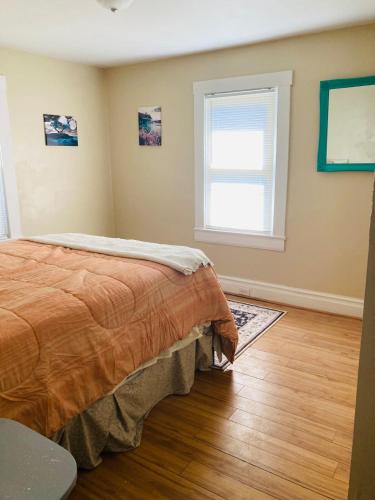 a bedroom with a bed and a window at The Humble House in Martinsville