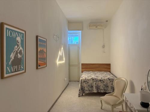 a room with a bed and a table and a chair at B&B Napul'è in Naples