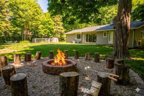 a fire pit in a yard next to a house at Stunning Ranch in the woods in Berrien Springs