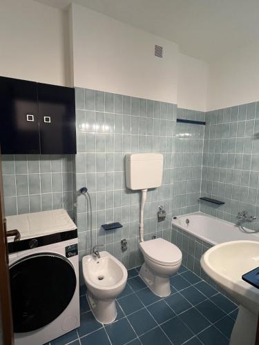 a bathroom with a toilet and a sink and a tub at Sea & Books Studio in Trieste