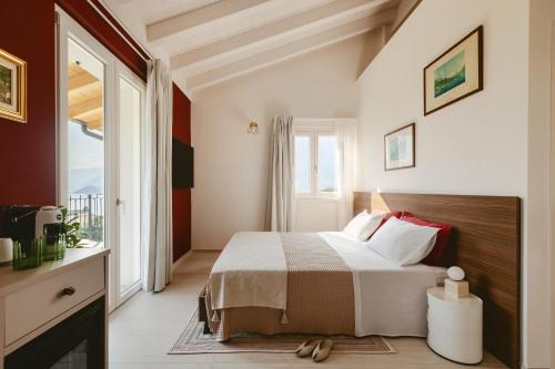 a bedroom with a bed and a large window at Hortus Bellagio in Bellagio