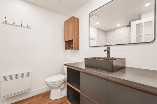 a bathroom with a sink and a toilet at 206 Val-des-Neiges - MSA LUX in Beaupré