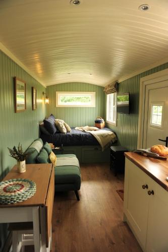 a living room with a bed and a couch at The Barraghan in Derrygonnelly