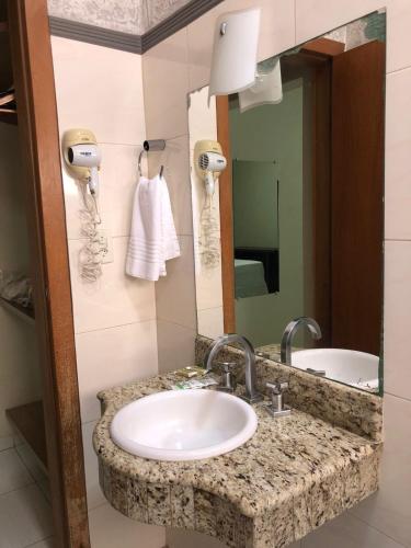 a bathroom with a sink and a mirror at Village Hotel in Cáceres