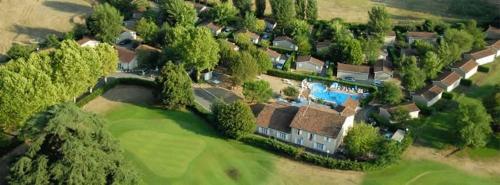 an aerial view of a house with a golf course at Chalet La Caz'à Joooh in Rivières