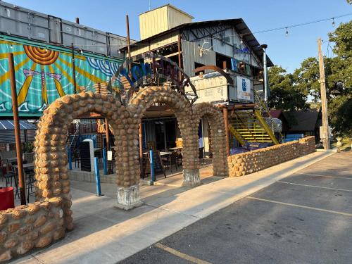 a building with an arch in the middle of a street at HT Innhabit rooftop view suite in Medicine Park