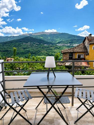 a table and chairs on a balcony with a view at Casa BuganVilla de Gredos in Mombeltrán