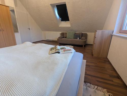 a bedroom with a bed and a couch in a room at Ferienwohnung Rheinwald in Hartheim