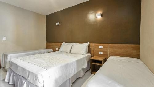 a hotel room with two beds at Safira Praia Hotel in Porto Seguro