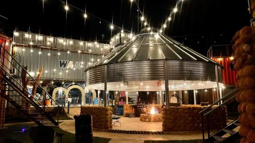 a large glass building with a person sitting in it at night at PPI Native American Theme suite in Medicine Park