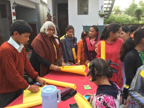 a group of people standing around a table with inflatables at The Hermitage Kanatal in Kanatal