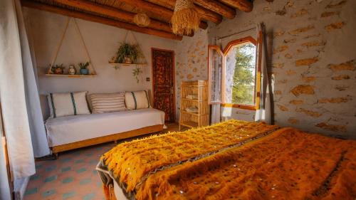 a bedroom with a large bed and a window at Bergerie Imsouane in Imsouane