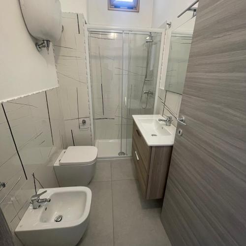 a bathroom with a sink and a toilet and a shower at Casa vacanze joppolo in Ioppolo