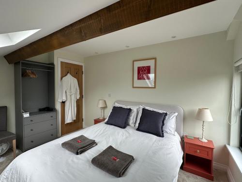 a bedroom with a bed with two towels on it at East Barn Bed & Breakfast in Wall