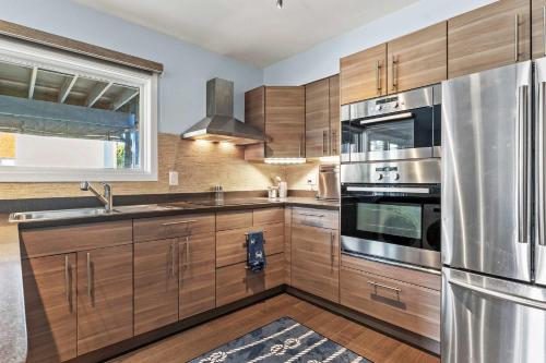a kitchen with wooden cabinets and stainless steel appliances at Spa Creek Condo Pool Deck & Parking in Annapolis