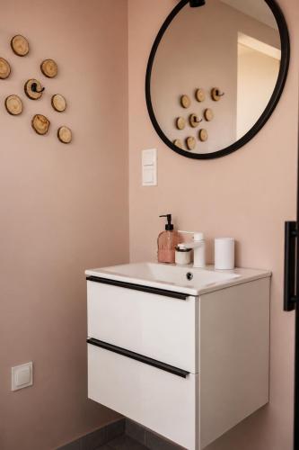 a bathroom with a white sink and a mirror at Osada Przejrzysko in Jordanów