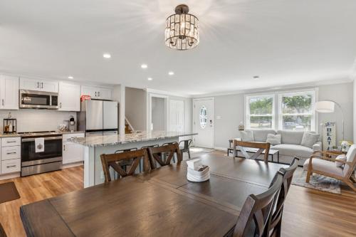a kitchen and living room with a table and chairs at Renovated 3BR Near Sandy Point Beach in Annapolis