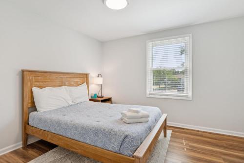 a white bedroom with a bed and a window at Renovated 3BR Near Sandy Point Beach in Annapolis
