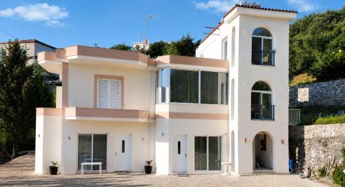 a white house on top of a hill at Villa Shelegar in (( Metoq ))