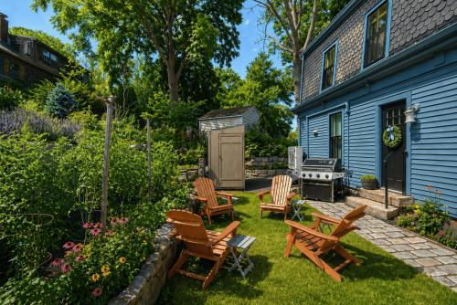 a backyard with rocking chairs and a grill at Pigeon Hill in Rockport
