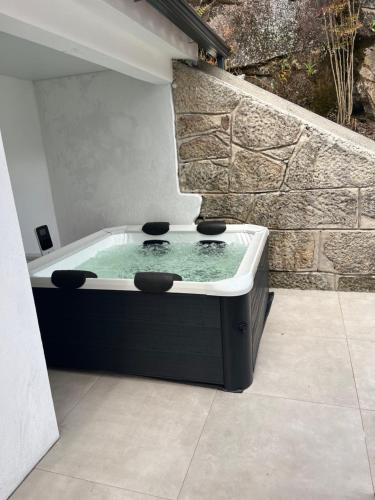 a bath tub with two stools in it at Casa De Cantoneiros in Campos