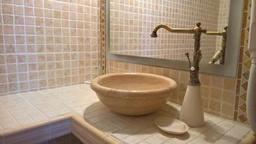 a bathroom with a bowl sink in a shower at Ethaleia Hotel in Moúdhros