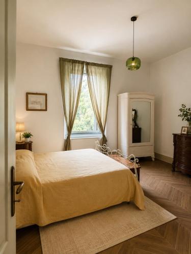 a bedroom with a large bed and a window at Fattoria Barca Colonna in Orbetello