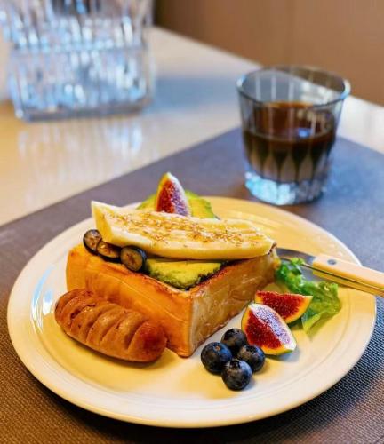 a plate of food with fruit on a table at Beijing Templeside Courtyard Hotel 丨 3 metros to the Square丨Free laundry, personalized services large terrace in Beijing