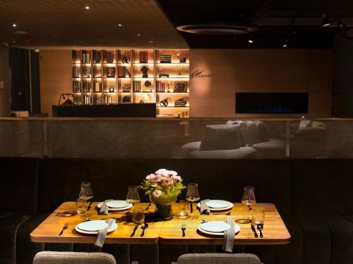 a table in a restaurant with glasses and flowers on it at Oliver Mexico City in Mexico City