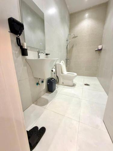 a white bathroom with a sink and a toilet at أورا ل التأجير اليومي للعائلات فقط in Jeddah