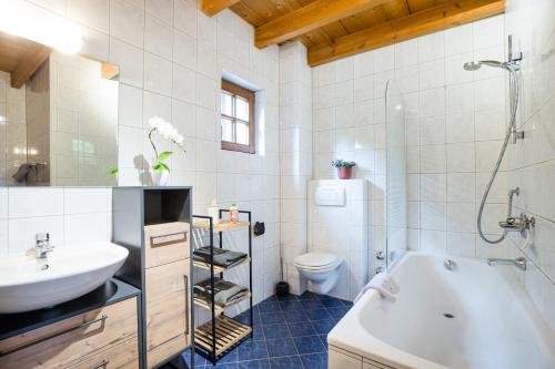 a bathroom with a tub and a sink and a toilet at Feel Good Place in Fritzens