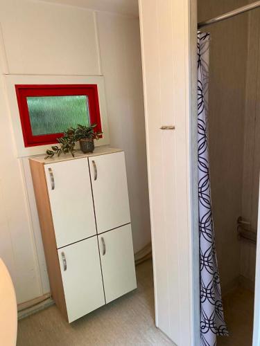 a room with a white cabinet and a window at Thy Glamping in Hurup