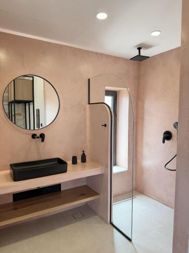 a bathroom with a glass shower and a mirror at Izel Villas in Skinária