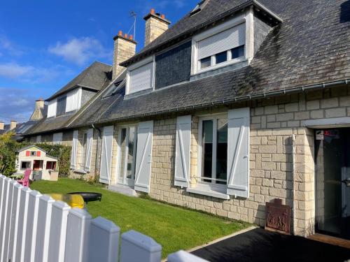 a house with a white fence in front of it at Chambre privée proche centre ville in Caen