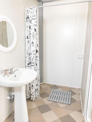 a bathroom with a sink and a shower at Camping Bucuria Bungalow in Eforie Nord