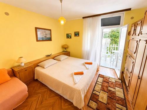 a bedroom with a large bed and a window at Igalo Apartment in Igalo